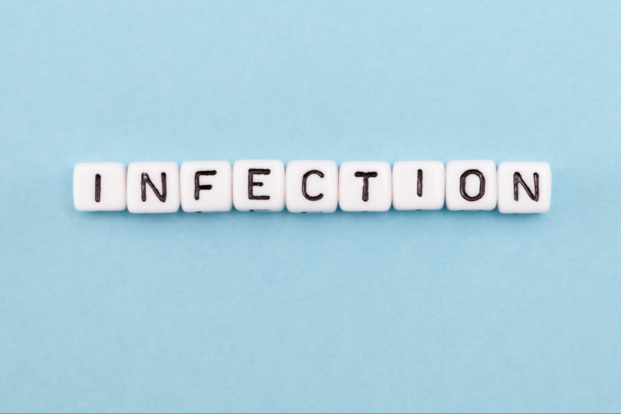 Scrabble-like letters spelling out the word “Infection” against a blue background.