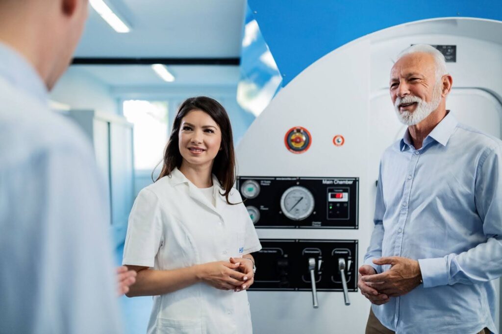 A doctor with patients before starting a hyperbaric chamber therapy session.
